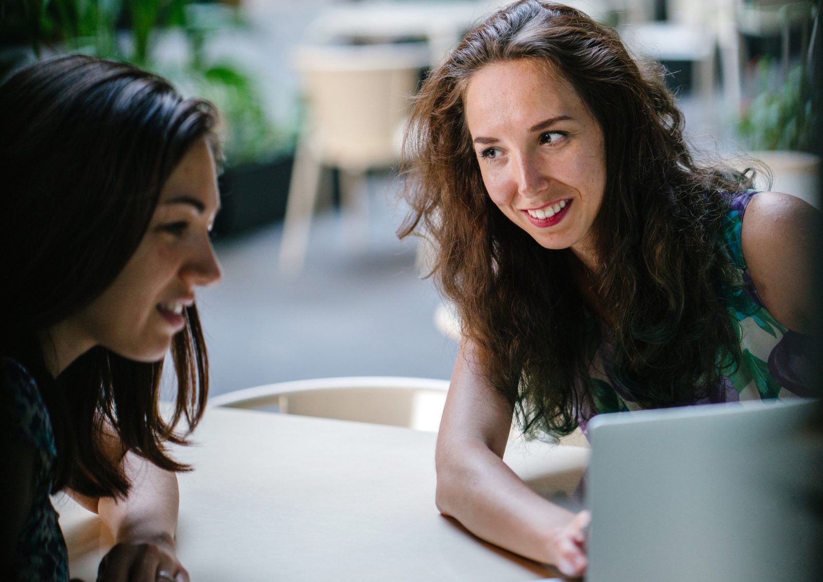 Two colleagues discussing a practice transition over a laptop